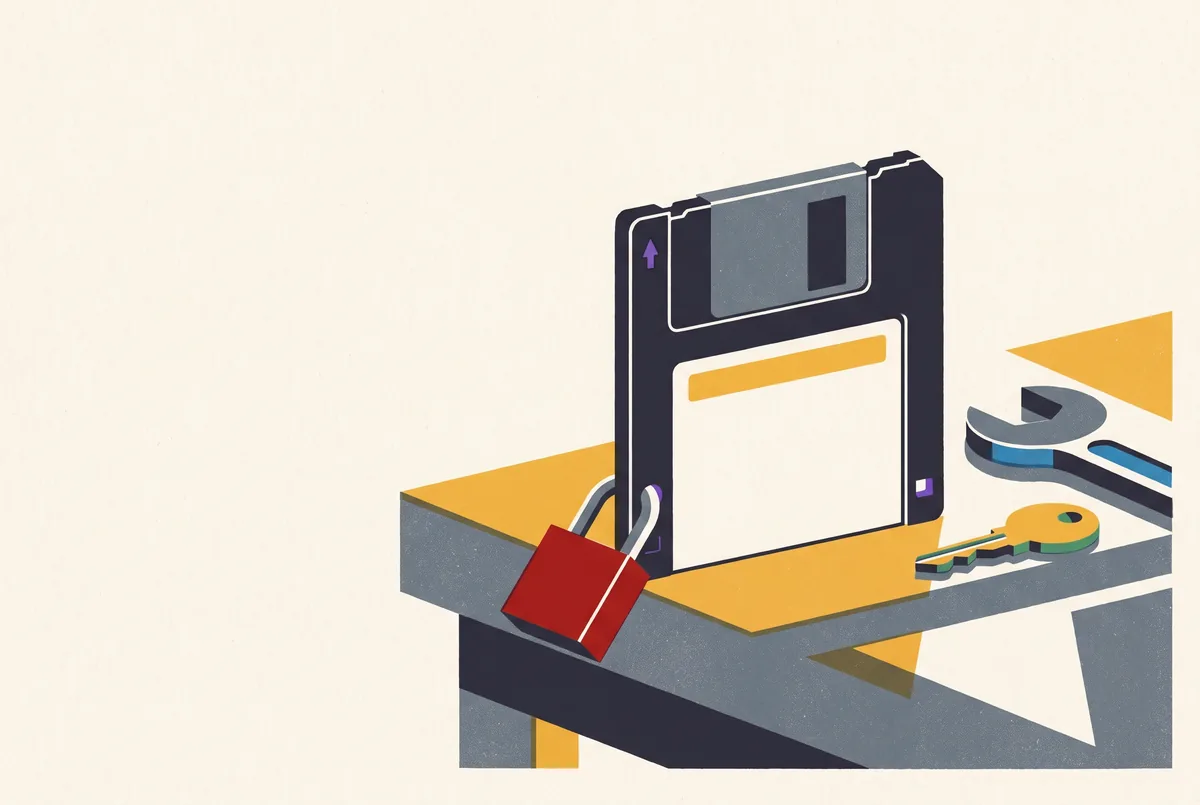Floppy met een rood hangslot op de werkbank.